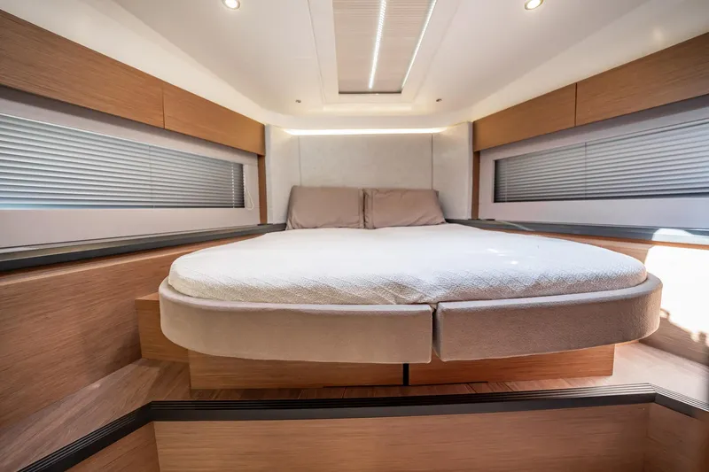 Kedem Plus Yacht Photos Pics Luxurious bedroom interior of 2021 Beneteau Monte Carlo 52 yacht, featuring modern design and cozy bedding.