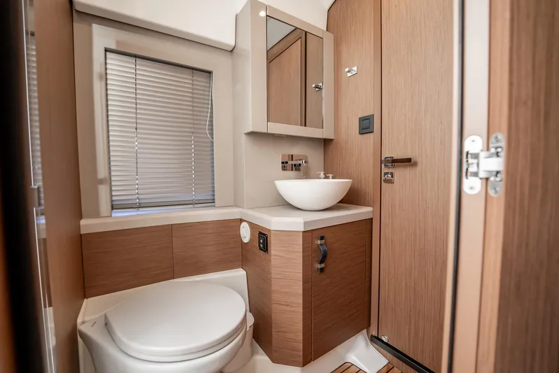Kedem Plus Yacht Photos Pics Luxury bathroom in 2021 Beneteau Monte Carlo 52 yacht, featuring modern fixtures and wood accents.