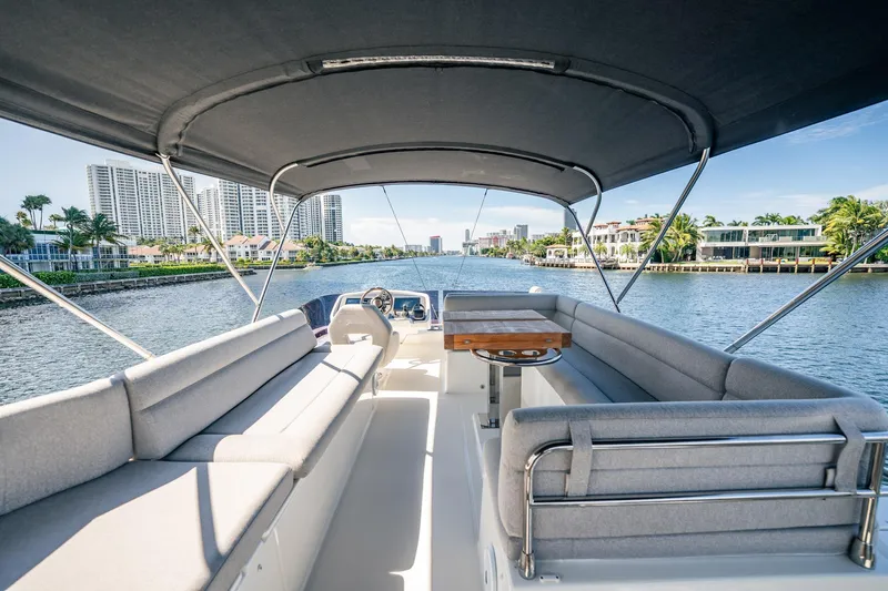 Kedem Plus Yacht Photos Pics Luxurious 2021 Beneteau Monte Carlo 52 yacht interior with spacious seating and scenic waterfront view.