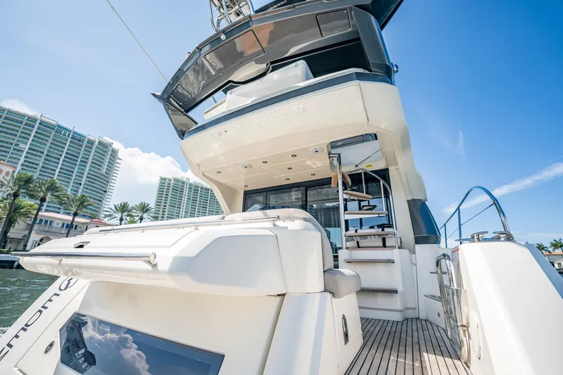 Kedem Plus Yacht Photos Pics 2021 Beneteau Monte Carlo 52 yacht, docked with modern architecture in the background.