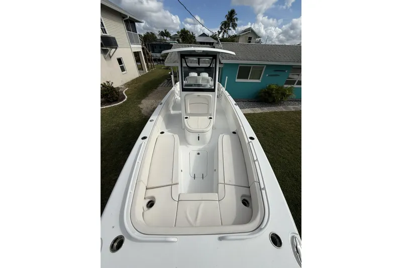  Yacht Photos Pics 2025 Sea Hunt Escape 28 boat with spacious deck and seating, docked near residential area.