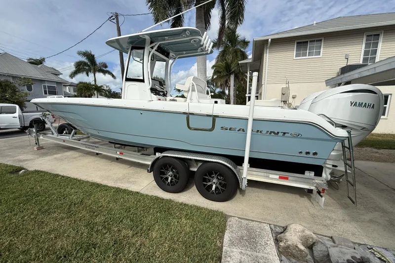  Yacht Photos Pics 2025 Sea Hunt Escape 28 boat on trailer, parked in residential driveway.