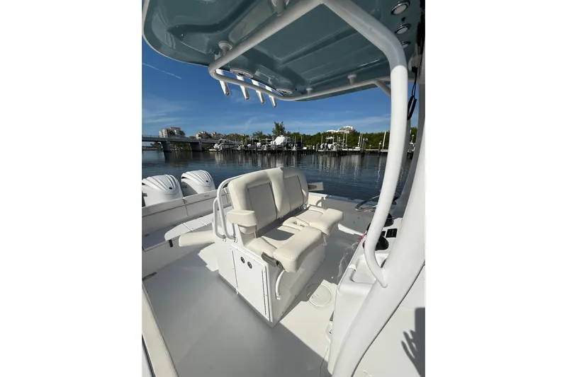  Yacht Photos Pics 2025 Sea Hunt Escape 28 boat interior with seating and dual engines, docked by a marina.