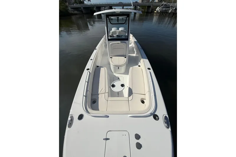  Yacht Photos Pics 2025 Sea Hunt Escape 28 boat with sleek design and spacious seating on calm water.