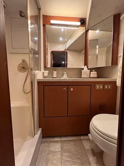 Reel Interest Yacht Photos Pics Bathroom interior of 2002 Ocean Yachts 56 Super Sport, featuring shower and vanity.