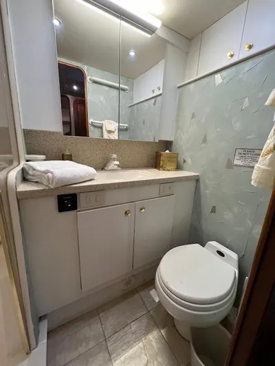 Reel Interest Yacht Photos Pics Bathroom interior of 2002 Ocean Yachts 56 Super Sport, featuring modern fixtures and ample storage.