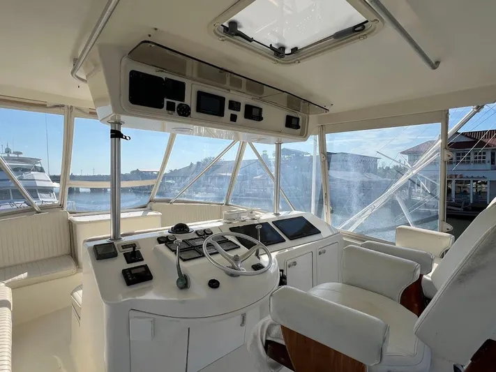 Reel Interest Yacht Photos Pics 2002 Ocean Yachts 56 Super Sport helm with modern controls and panoramic marina view.