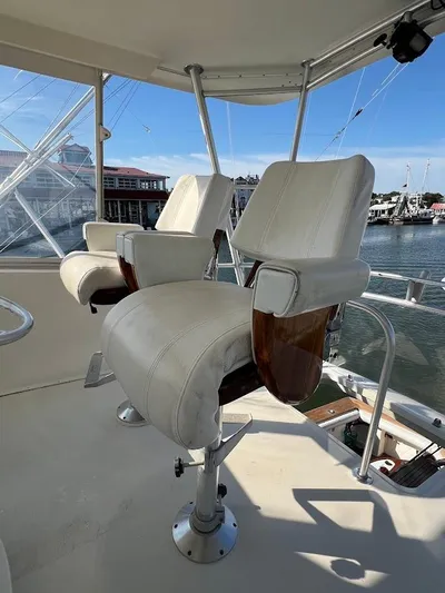 Reel Interest Yacht Photos Pics 2002 Ocean Yachts 56 Super Sport helm chairs with marina view.