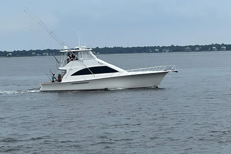 Reel Interest Yacht Photos Pics 2002 Ocean Yachts 56 Super Sport cruising on calm waters.