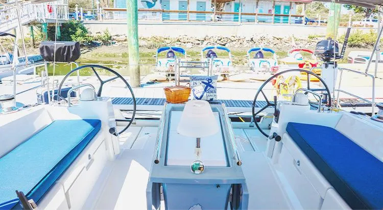 New Horizon Yacht Photos Pics 2018 Beneteau Oceanis 45 yacht cockpit with dual steering wheels and blue seating.