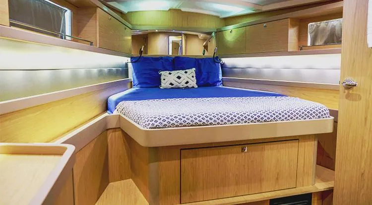 New Horizon Yacht Photos Pics 2018 Beneteau Oceanis 45 interior cabin with cozy bed and modern wood finish.