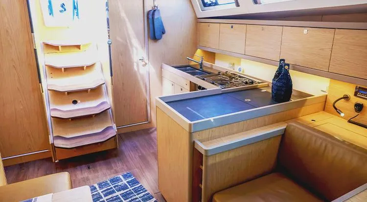 New Horizon Yacht Photos Pics Interior of 2018 Beneteau Oceanis 45 yacht, featuring modern kitchen and seating area.