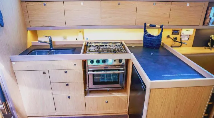 New Horizon Yacht Photos Pics Modern kitchen in 2018 Beneteau Oceanis 45 yacht with stove, sink, and ample storage.