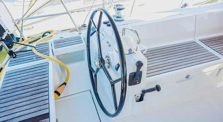 New Horizon Yacht Photos Pics 2018 Beneteau Oceanis 45 yacht cockpit with steering wheel and wooden seating.