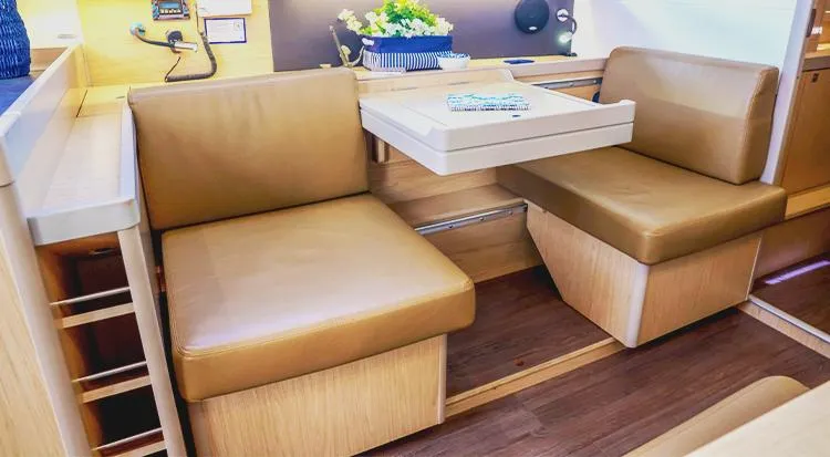 New Horizon Yacht Photos Pics Interior of 2018 Beneteau Oceanis 45 yacht with tan seating and wooden accents.
