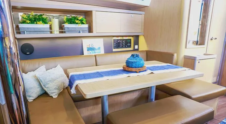 New Horizon Yacht Photos Pics Interior of 2018 Beneteau Oceanis 45 yacht with cozy dining area and modern decor.
