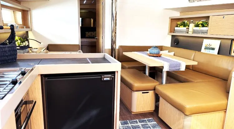 New Horizon Yacht Photos Pics Interior of 2018 Beneteau Oceanis 45 yacht with modern kitchen and cozy dining area.