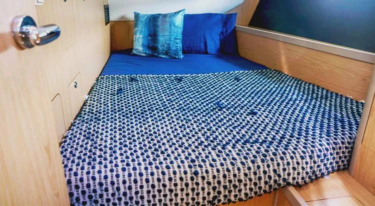 New Horizon Yacht Photos Pics Cozy cabin bed in 2018 Beneteau Oceanis 45 yacht with blue bedding.