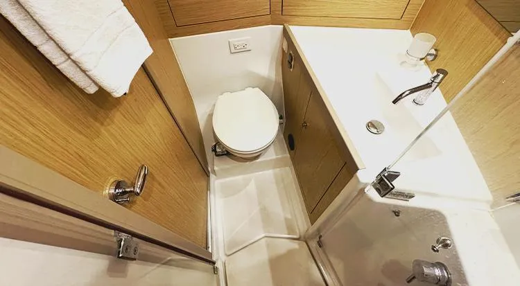 New Horizon Yacht Photos Pics 2018 Beneteau Oceanis 45 yacht bathroom with modern fixtures and wooden cabinetry.