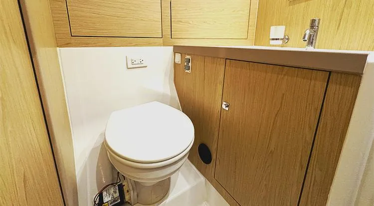 New Horizon Yacht Photos Pics 2018 Beneteau Oceanis 45 yacht bathroom with wooden cabinetry and modern fixtures.