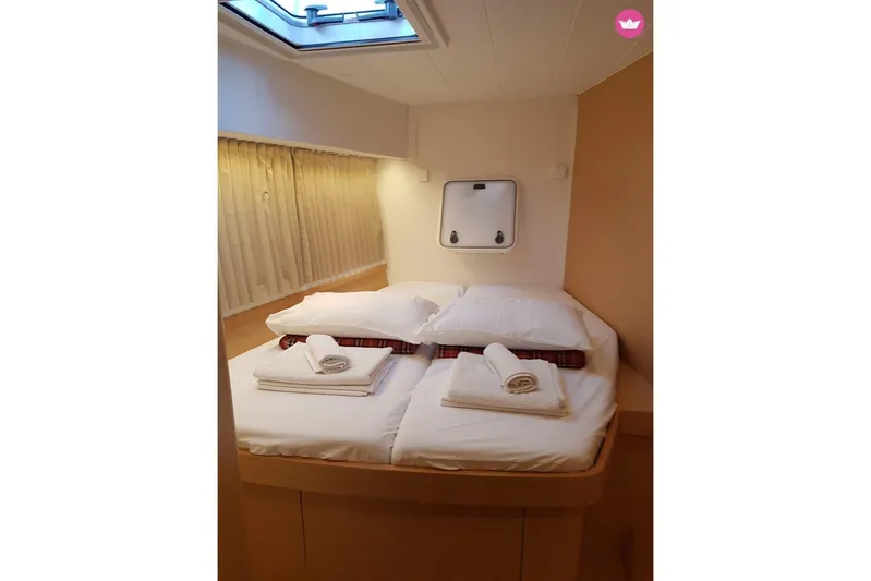  Yacht Photos Pics Cozy cabin interior of 2019 Lagoon 42 yacht with neatly arranged bedding.