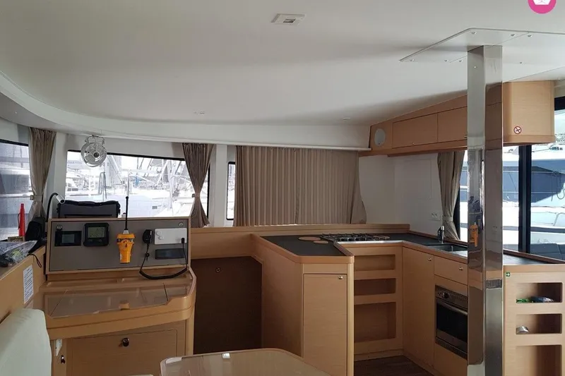  Yacht Photos Pics Interior of 2019 Lagoon 42 catamaran with modern kitchen and navigation equipment.