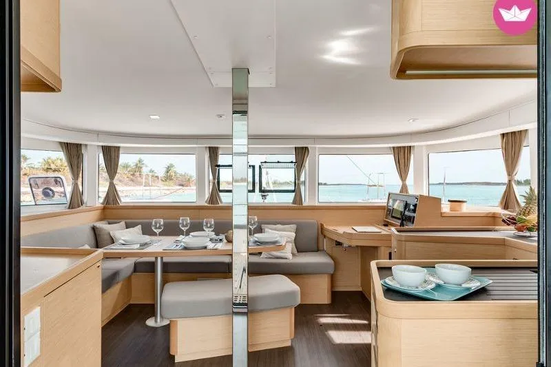  Yacht Photos Pics Interior of 2019 Lagoon 42 catamaran with elegant dining area and ocean view.