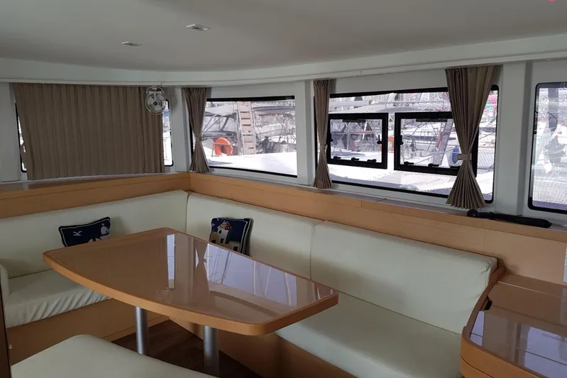  Yacht Photos Pics Interior of 2019 Lagoon 42 catamaran with spacious seating and large windows.
