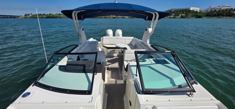  Yacht Photos Pics 2019 Sea Ray SDX 290 Outboard boat on water, featuring spacious seating and blue canopy.