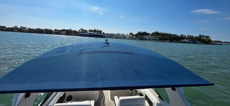  Yacht Photos Pics 2019 Sea Ray SDX 290 Outboard cruising on a sunny day, with clear blue skies.