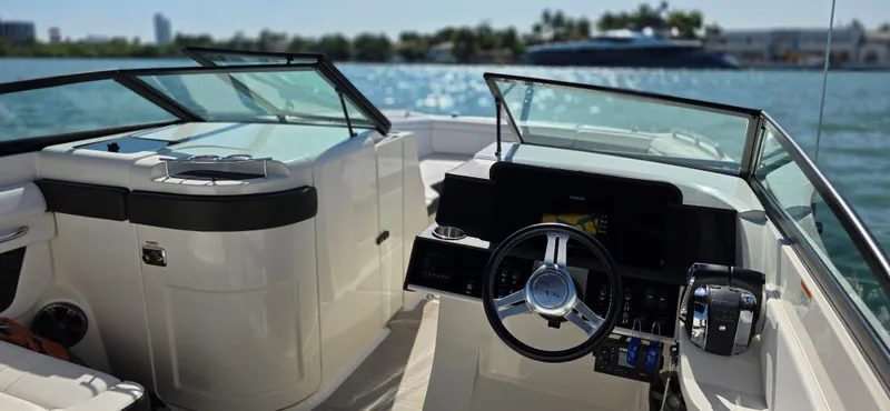  Yacht Photos Pics 2019 Sea Ray SDX 290 Outboard boat interior with steering wheel, dashboard, and waterfront view.