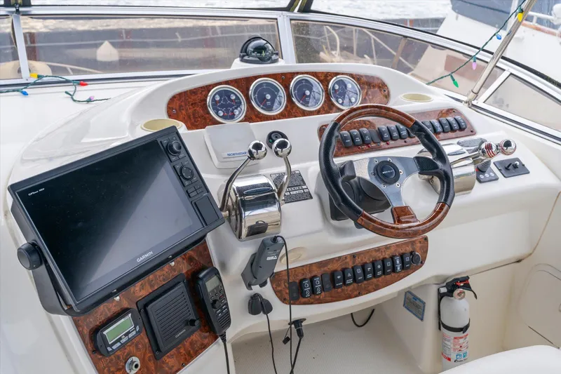 Barbarrick Yacht Photos Pics 2006 Meridian 411 Sedan helm with steering wheel, navigation system, and control panel.