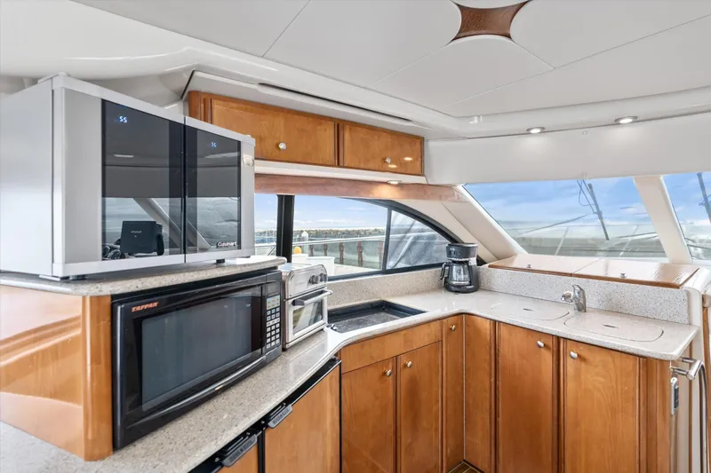 Barbarrick Yacht Photos Pics Luxurious kitchen interior of 2006 Meridian 411 Sedan yacht with modern appliances.