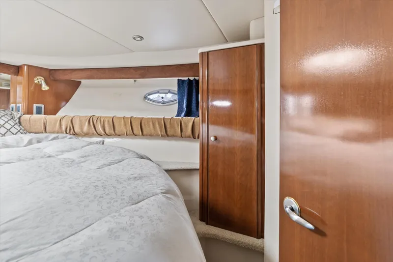 Barbarrick Yacht Photos Pics Luxurious interior of 2006 Meridian 411 Sedan yacht with wood finishes and cozy bedding.