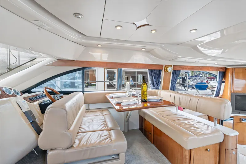 Barbarrick Yacht Photos Pics Luxurious interior of 2006 Meridian 411 Sedan yacht with dining area and helm station.