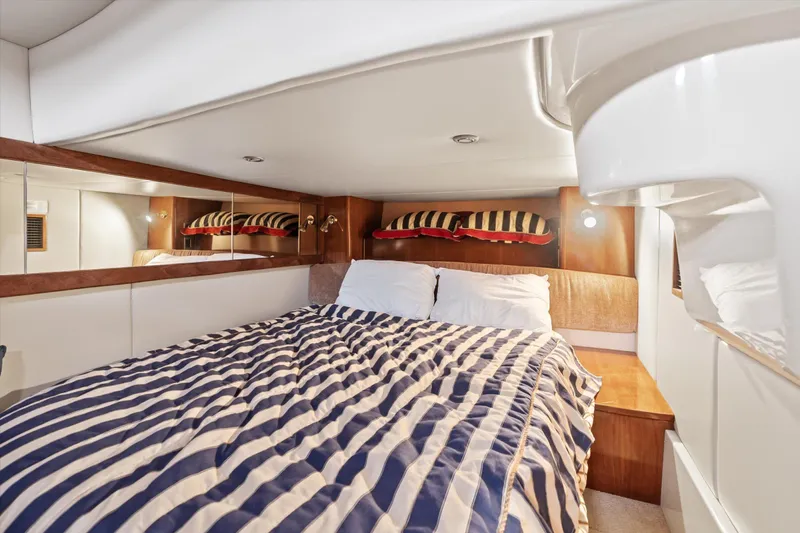 Barbarrick Yacht Photos Pics Luxurious cabin interior of 2006 Meridian 411 Sedan yacht with striped bedding.