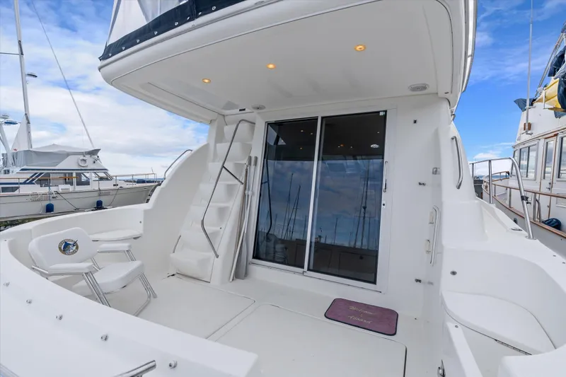 Barbarrick Yacht Photos Pics 2006 Meridian 411 Sedan yacht deck with seating and sliding glass doors.