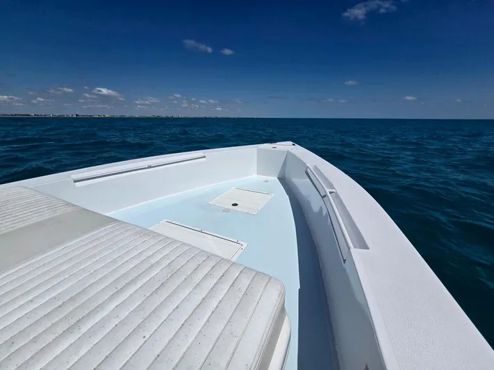  Yacht Photos Pics 2012 Contender Custom 33 Center Console boat on open ocean under clear blue sky.