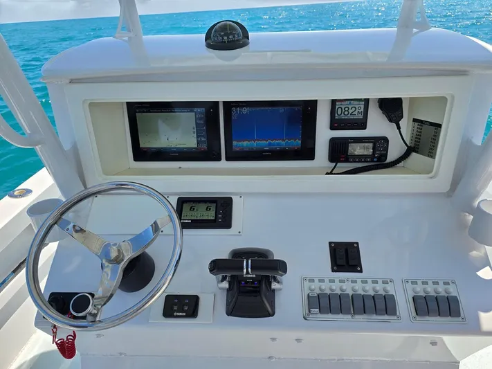  Yacht Photos Pics 2012 Contender Custom 33 Center Console dashboard with steering wheel and navigation displays.