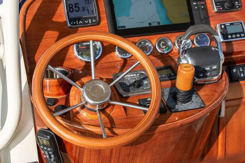 Cheetah Yacht Photos Pics Helm of 2014 Hinckley T29 CC boat with wooden steering wheel and navigation controls.