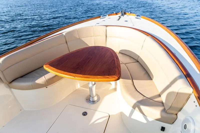 Cheetah Yacht Photos Pics 2014 Hinckley T29 CC boat interior with elegant seating and wooden table on the water.