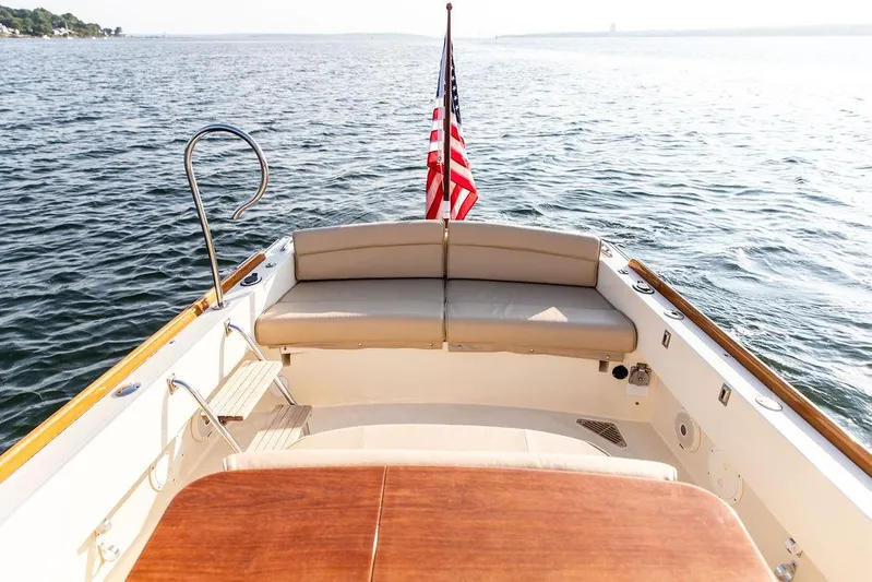 Cheetah Yacht Photos Pics 2014 Hinckley T29 CC boat with American flag on calm water.