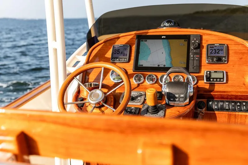 Cheetah Yacht Photos Pics Helm of 2014 Hinckley T29 CC boat with navigation instruments and wooden steering wheel.