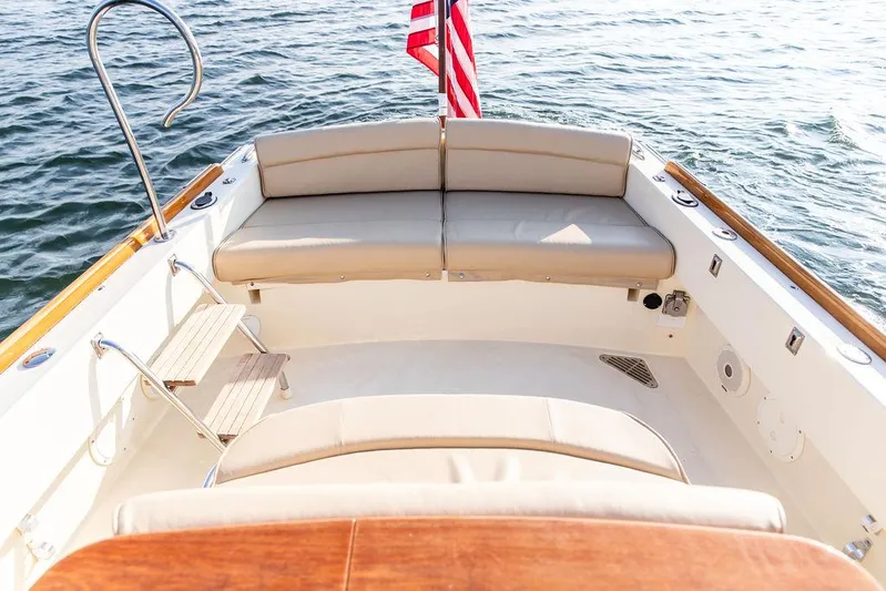 Cheetah Yacht Photos Pics 2014 Hinckley T29 CC boat interior with seating and American flag on water.