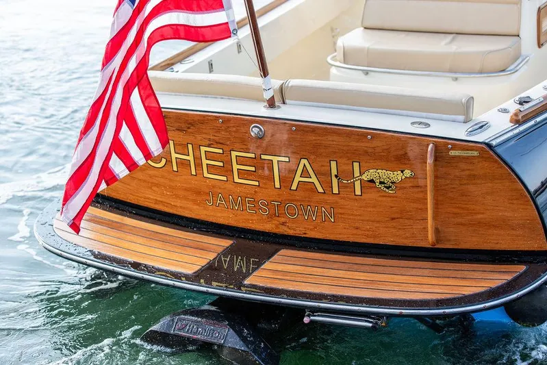 Cheetah Yacht Photos Pics Hinckley T29 CC 2014 boat with American flag and "Cheetah" nameplate on wooden stern.
