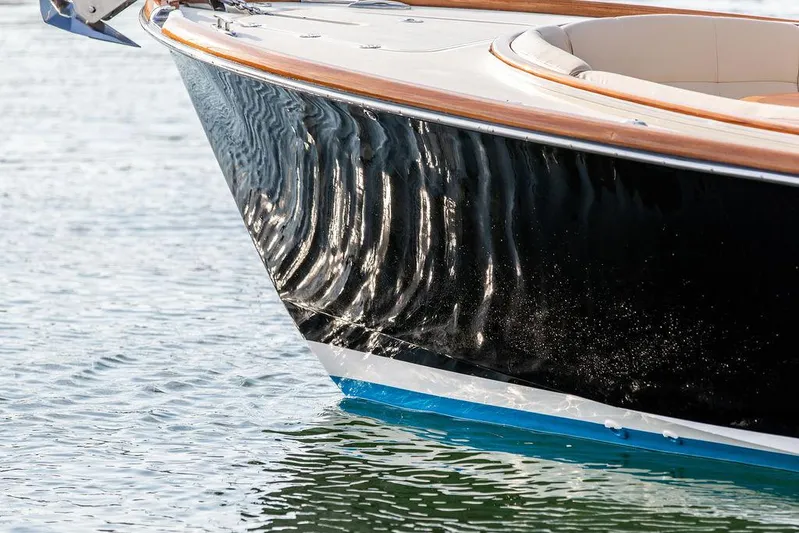 Cheetah Yacht Photos Pics 2014 Hinckley T29 CC boat with sleek black hull on water.