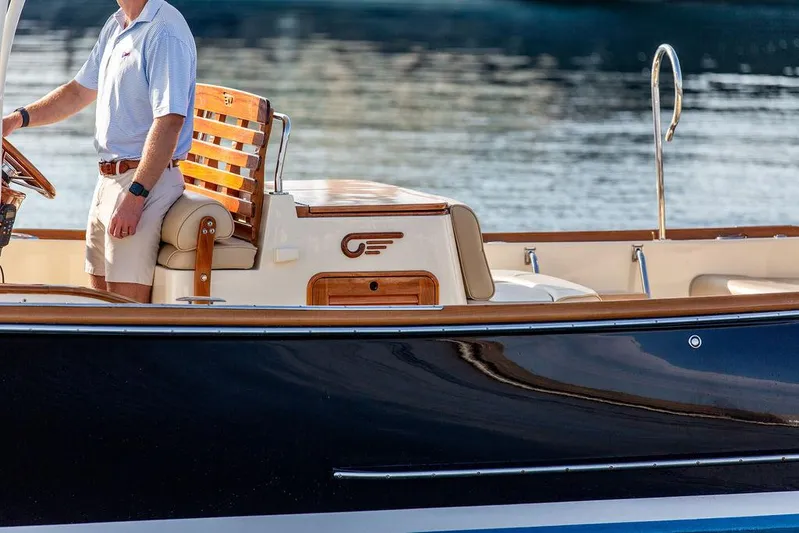 Cheetah Yacht Photos Pics 2014 Hinckley T29 CC boat with wooden seating and elegant design on calm water.
