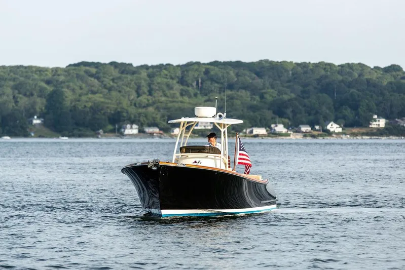 Cheetah Yacht Photos Pics 2014 Hinckley T29 CC boat cruising on a scenic lake with forested shoreline.