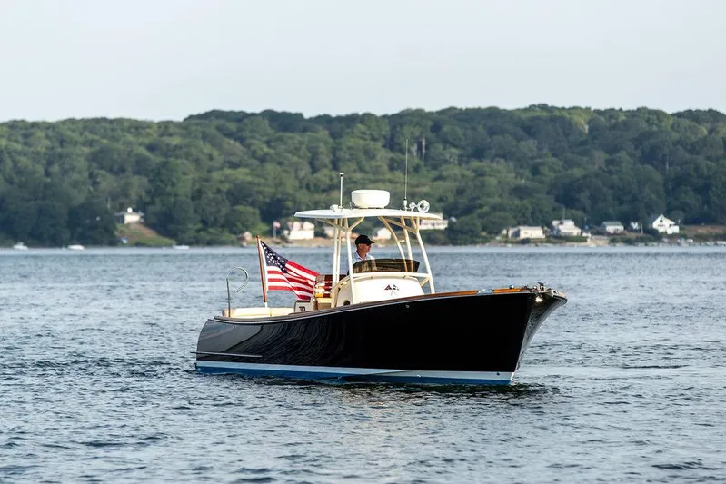 Cheetah Yacht Photos Pics 2014 Hinckley T29 CC boat cruising on a lake with American flag.