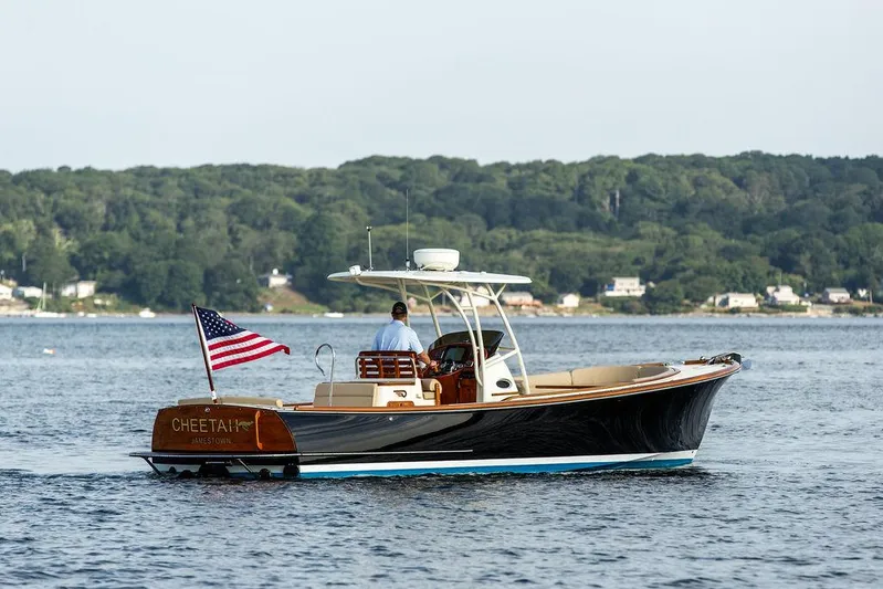 Cheetah Yacht Photos Pics 2014 Hinckley T29 CC boat cruising on a calm lake with American flag.
